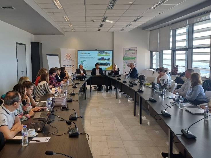 people gathered  in a room, looking at presentation