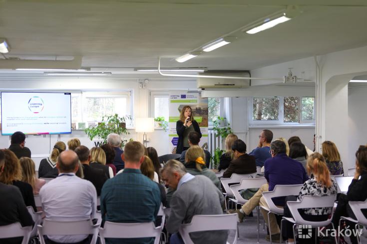 Full conference room with one speaker presenting