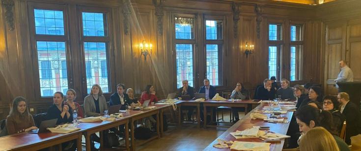 Experts and stakeholders at a large meeting table