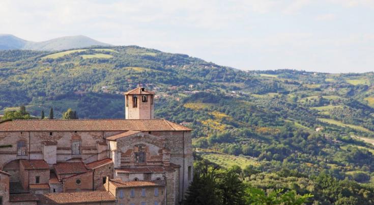 outdoor scene of old buildings overlooking a springtime landscape