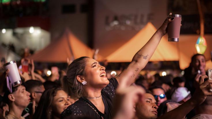 People having fun at a concert using reusable cups