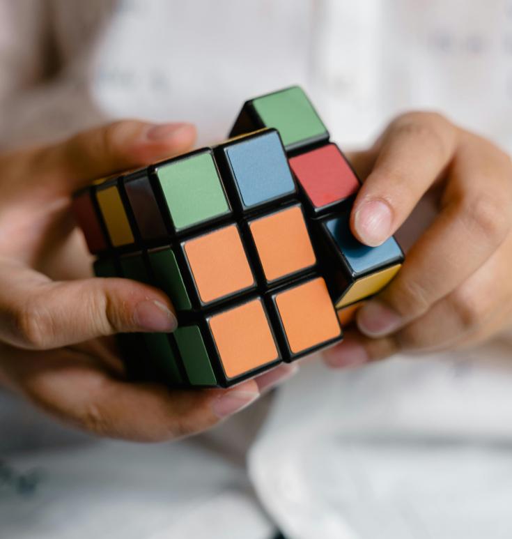 A person playing with a rubiks cube