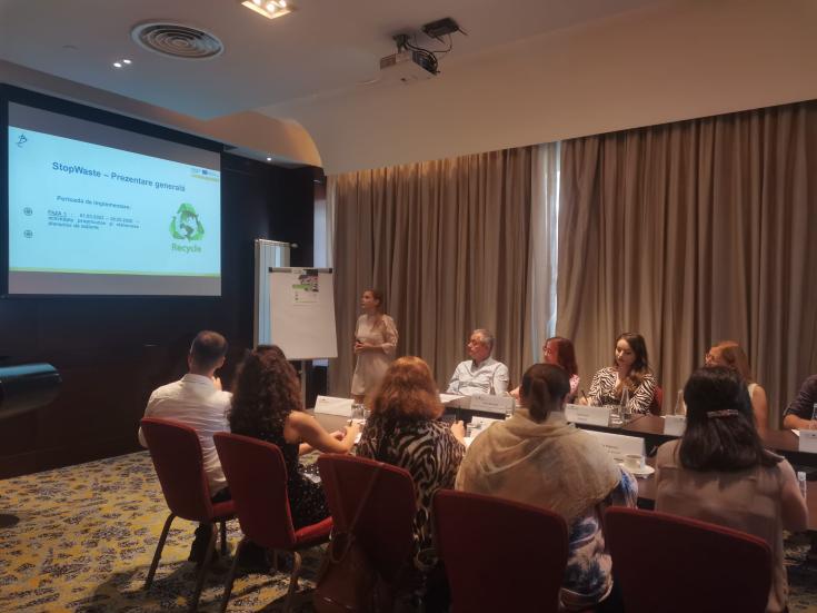 people in meeting presenting STOPWASTE project