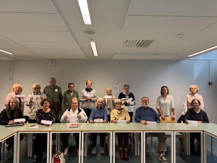 A group of students from the community college. The picture shows a group of students from the Community College who have written ideas about AI on bookmarks.