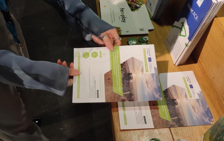 MINEV brochure on a table of communication materials