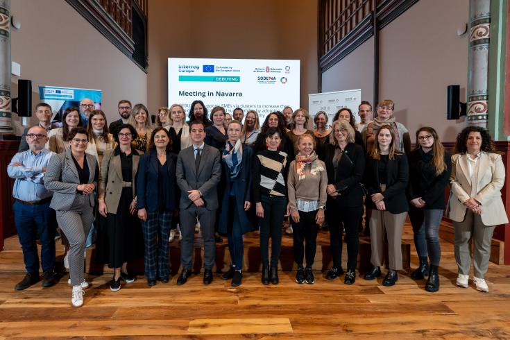 Group photo of the DEBUTING consortium in a meeting room in Pamplona.