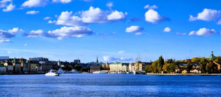 Europe, let's cooperate! interregional cooperation forum takes place on 15 March 2023 in Stockholm (Sweden) skyline of Stockholm pictured from the seaside with water, buildings, trees, blue sky and some clouds