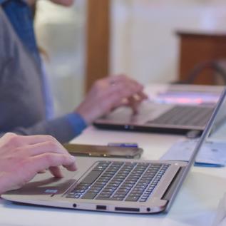 People typing on laptops People typing on laptops