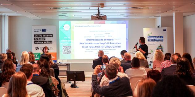 European Week of Regions and Cities 2023 person presenting and audience looking towards the presenter