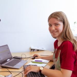 Youth volunteer works at desk