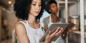 Women Standing in a new business premises looking at a Tablet 