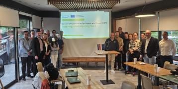 GIFT 3rd Interregional Meeting participants in the workshop room next to the project slide.