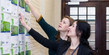 Two women looking at pamphlets