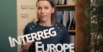 Interreg Europe tips for project preparation Person holding signs with words Interreg and Europe