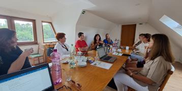 A group of people sitting and discussing in a meeting room