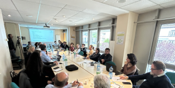 People around a meeting table having a conference