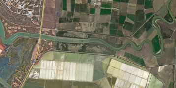 Aerial photo of Spanish river delta with salt production areas as white  squares on the scenerey