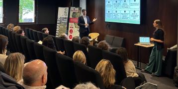 Speakers and people in a meeting room