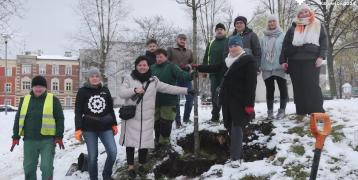 People together outside gardening in the snow but posing for the picture