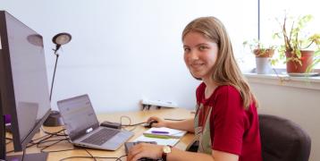 Youth volunteer works at desk