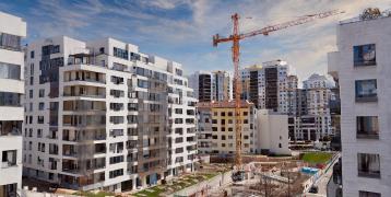 City filled with high buildings and cranes building new buildings