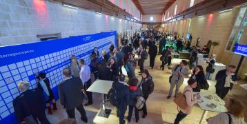 Crowd of people network at 'Europe, let's cooperate' 2017 Crowd of people in a hall way networking at an event.
