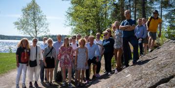 Group photo of project team partners standing by the lakeside