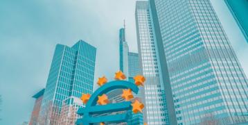 Euro sign in front of highrise buildings Euro sign in front of highrise buildings