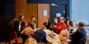 Group of people speaking around a table