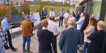 Group of people standing on terrace discussing