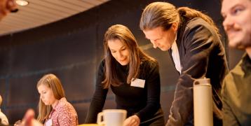 People looking at something on a table