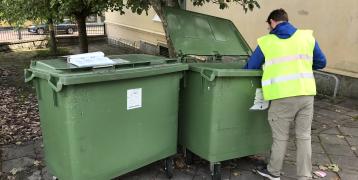 One of the environmental educators goes through the waste at one of our municipal departments