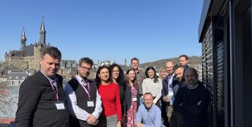 Project partners posing for a photo with Aachen cathedral in background.