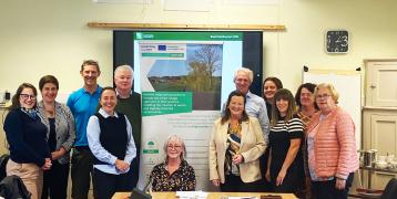 INSPIRE Ballyhoura Development Regional Stakeholder Meeting with Coote Hall, Kilmallock, Co. Limerick, posing for a photo in front of the INSPIRE Roll Up Banner