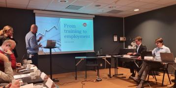 Participants listen to a male speaker, representing during the Peer Review in Kristiansand. 