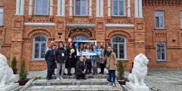 Project partners standing in front of the building during the kick-off meeting in the city of Nowy Dwór Mazowiecki.