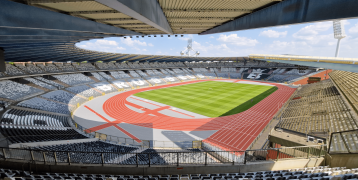 An empty King Baudouin Stadium with the Atomium in the background