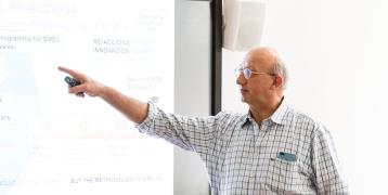 Man showing something on digital board