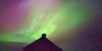Northern lights over a house