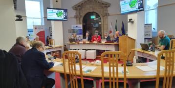 Southern Regional Assembly members sitting in Assembly Chamber watching PROXIMITIES presentation