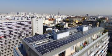 A photovoltaic (PV) installation on top of a residential building