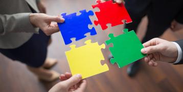 People holding puzzle pieces