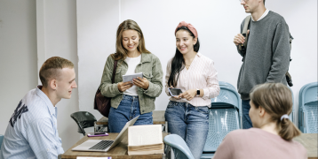 People sitting and standing around table