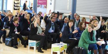 People sitting on stools during event