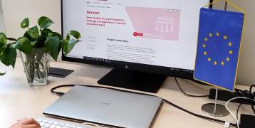 Person typing at computer in front of project website Person typing at computer in front of project website
