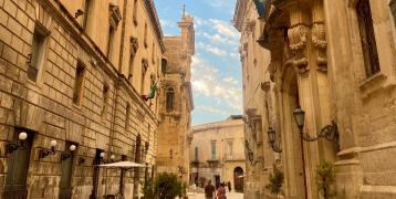 Two people walking in a baroque style street