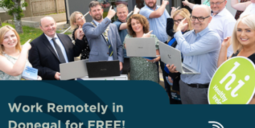 Group of people promoting the "Work Remotely in Donegal for FREE!" outside a remote working hub.