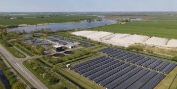 Rows of solar panels in a vast field