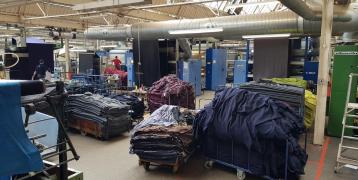 Large piles of different textiles in a factory