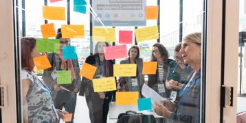 workshop participants looking at colourful post-it notes